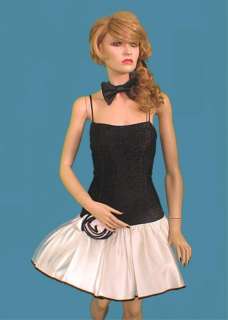 This 80s mini prom dress features a full skirt, a black shiny bodice 