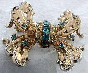 GOLD TONE BROOCH WITH BLUE & CLEAR STONES BY CORA  