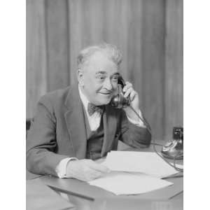  Elderly Businessman, Sitting at Desk, Talking on Telephone 