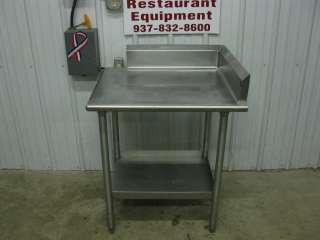   looking at a stainless steel corner work table w/ side & back splash