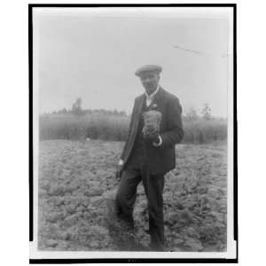   ,1864 1943,probably at Tuskegee,holding piece of soil