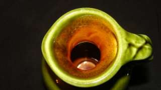 Beautiful small (approx 4 1/4 inch) dark green art pottery jug. Has 